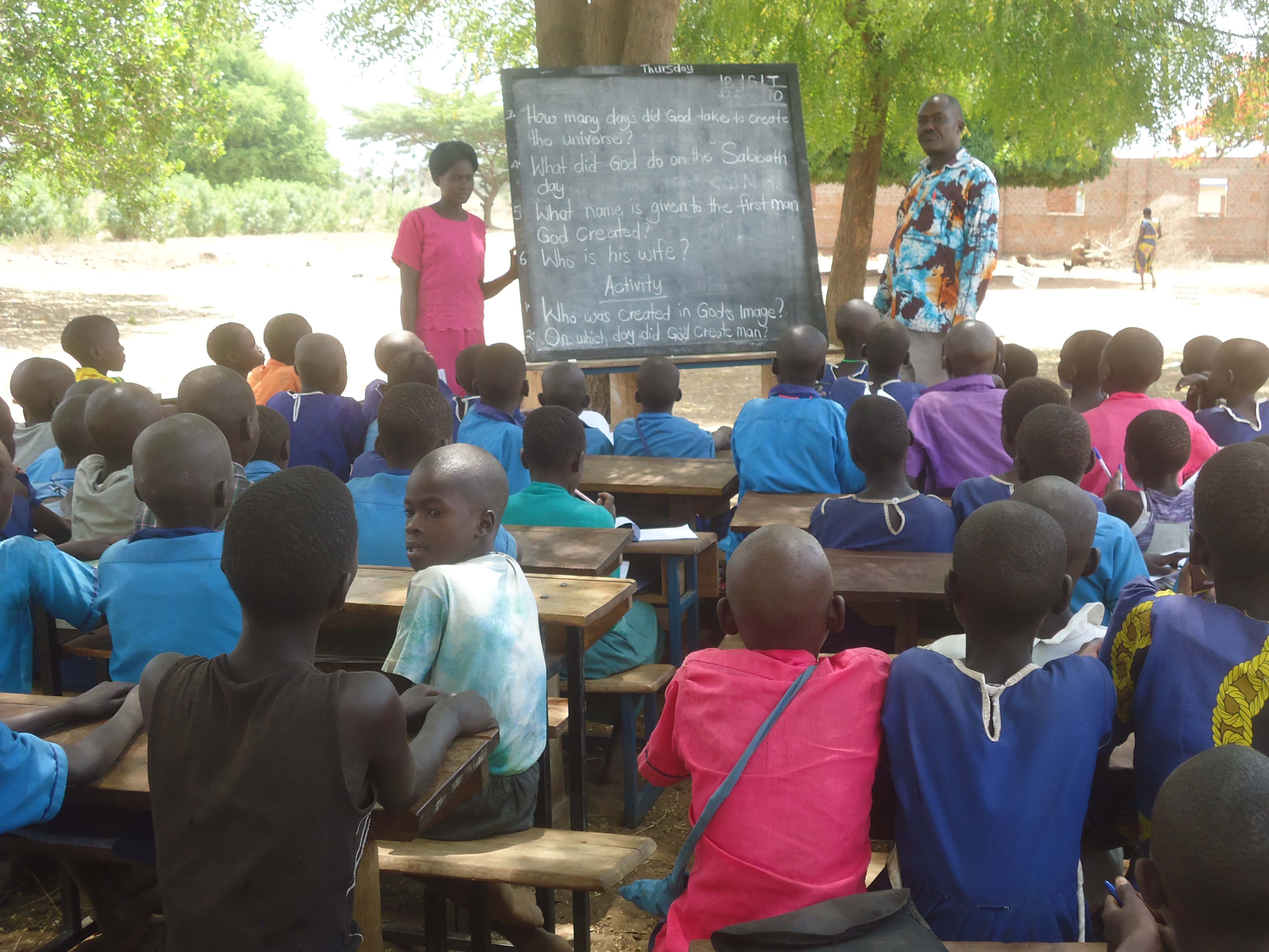 Christine Among teaching P.3 pupils SST under the tamarind treeBy TND News
