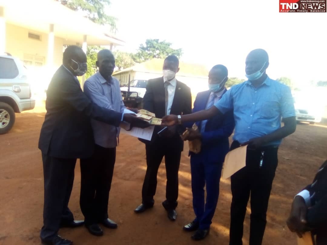 Ministers shs20 cash being recieved by Lira disterict officials on Wednesday.