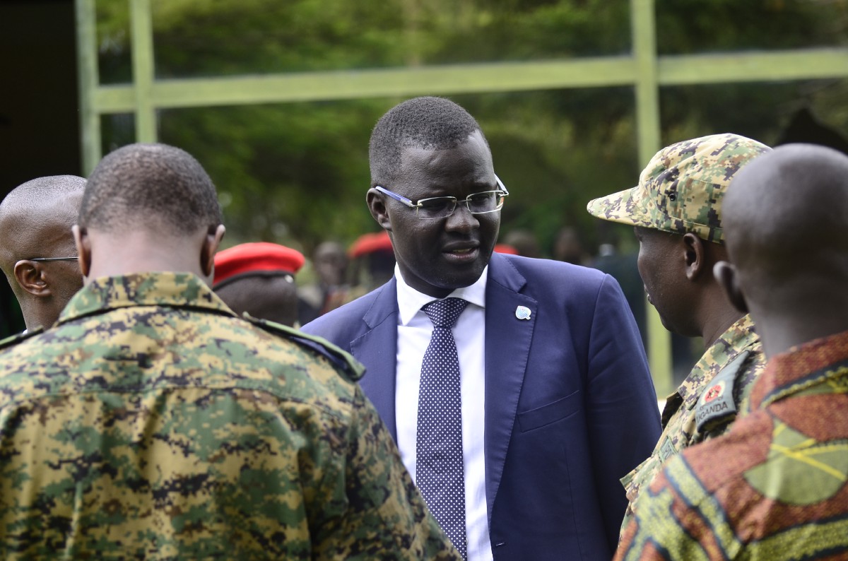 Nicholas Opiyo M chats with men in uniform at a past event. Courtesy photo.